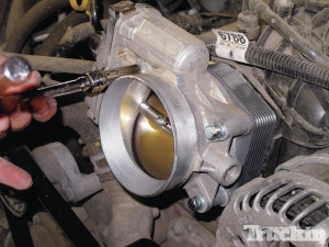 an aFe Silver Bullet Throttle Body Spacer installed on a Chevy Truck. Image Source: Truckin'