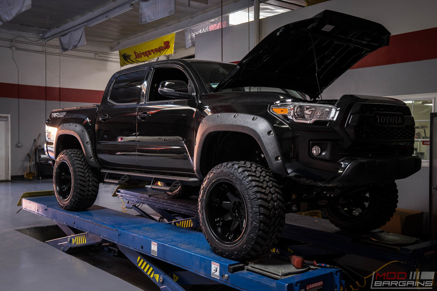 toyota tacoma murdered black trd offroad fuel offroad nitto trail grappler magnaflow exhaust pro comp lift kit diode dynamics LED